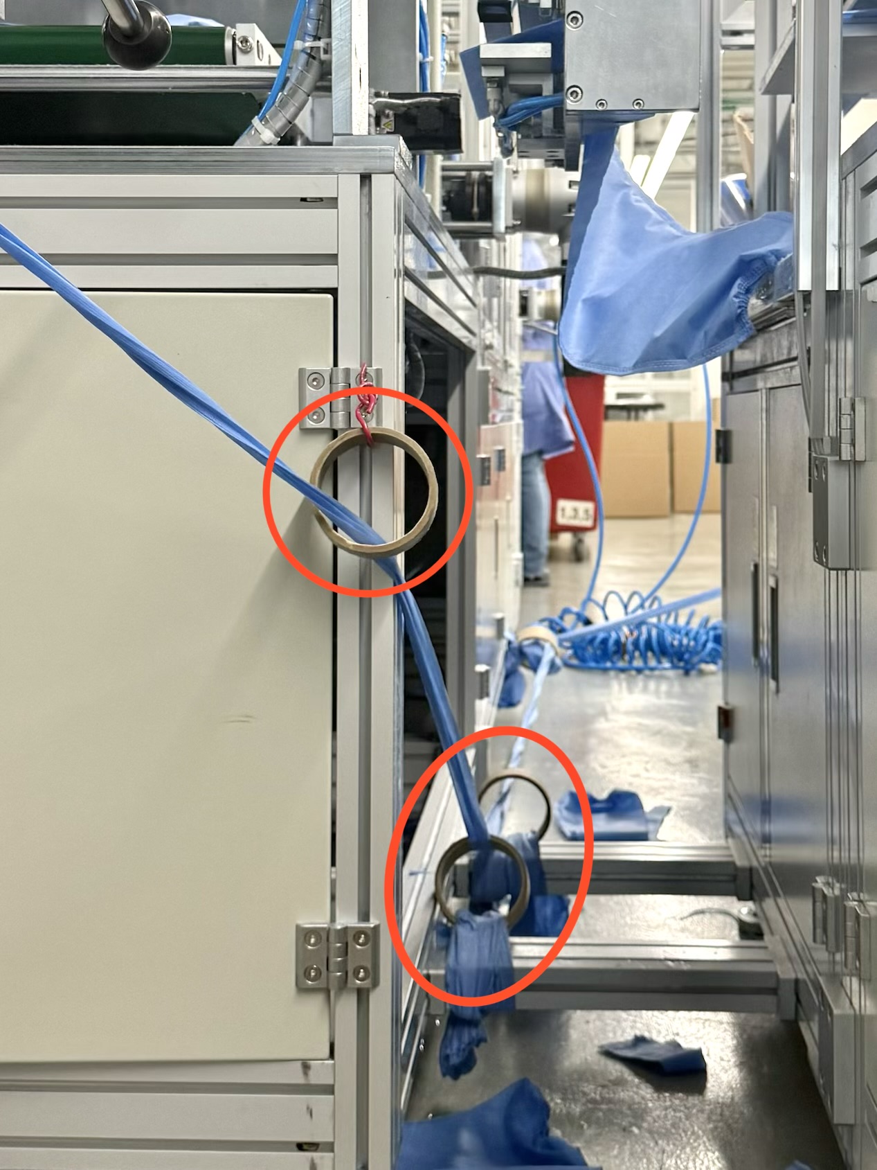 Production machine showing empty tape rolls used to route excess fabric
