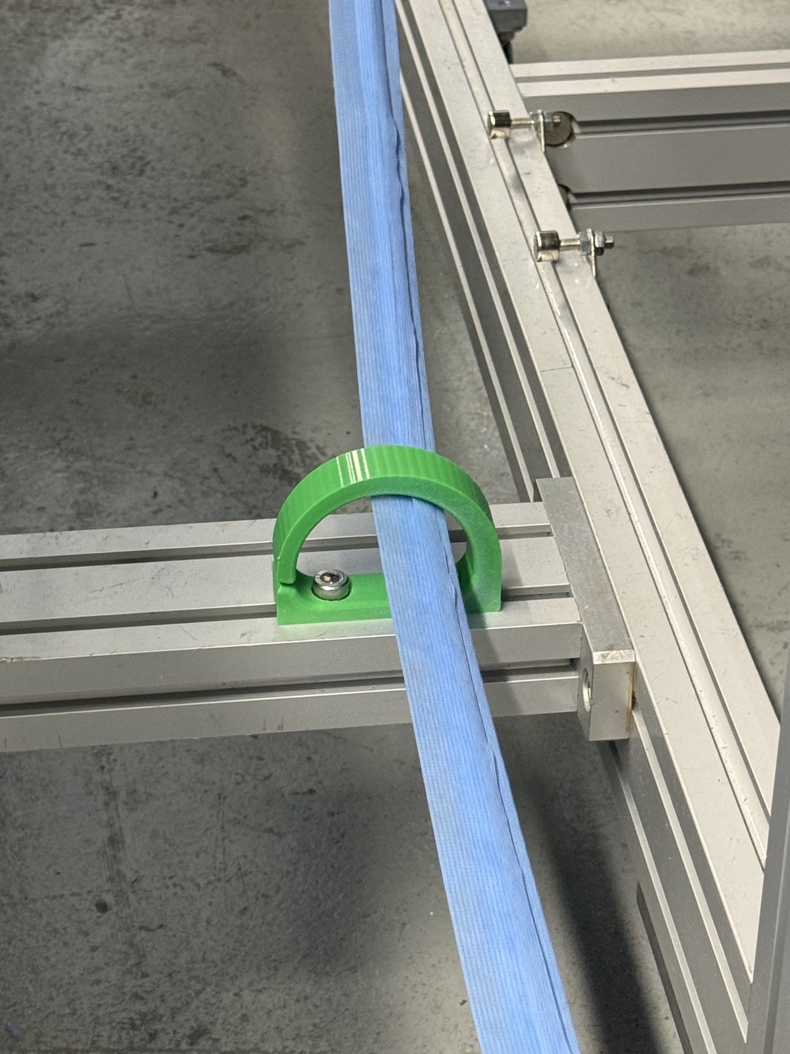 Final green waste-fabric guide installed on the aluminum machine frame